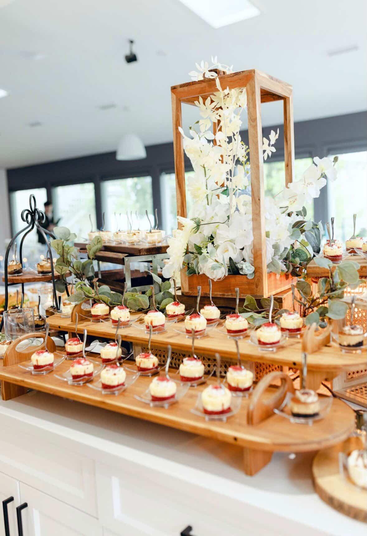 Mini-cheesecake dessert display with white floral lantern