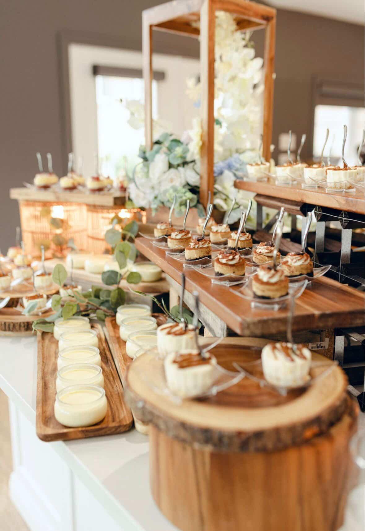 Tiramisu and panna cotta dessert station with wooden risers and eucalyptus