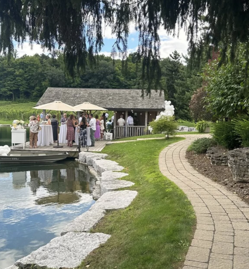Cocktail hour at the gazebo with white balloons and outdoor umbrellas