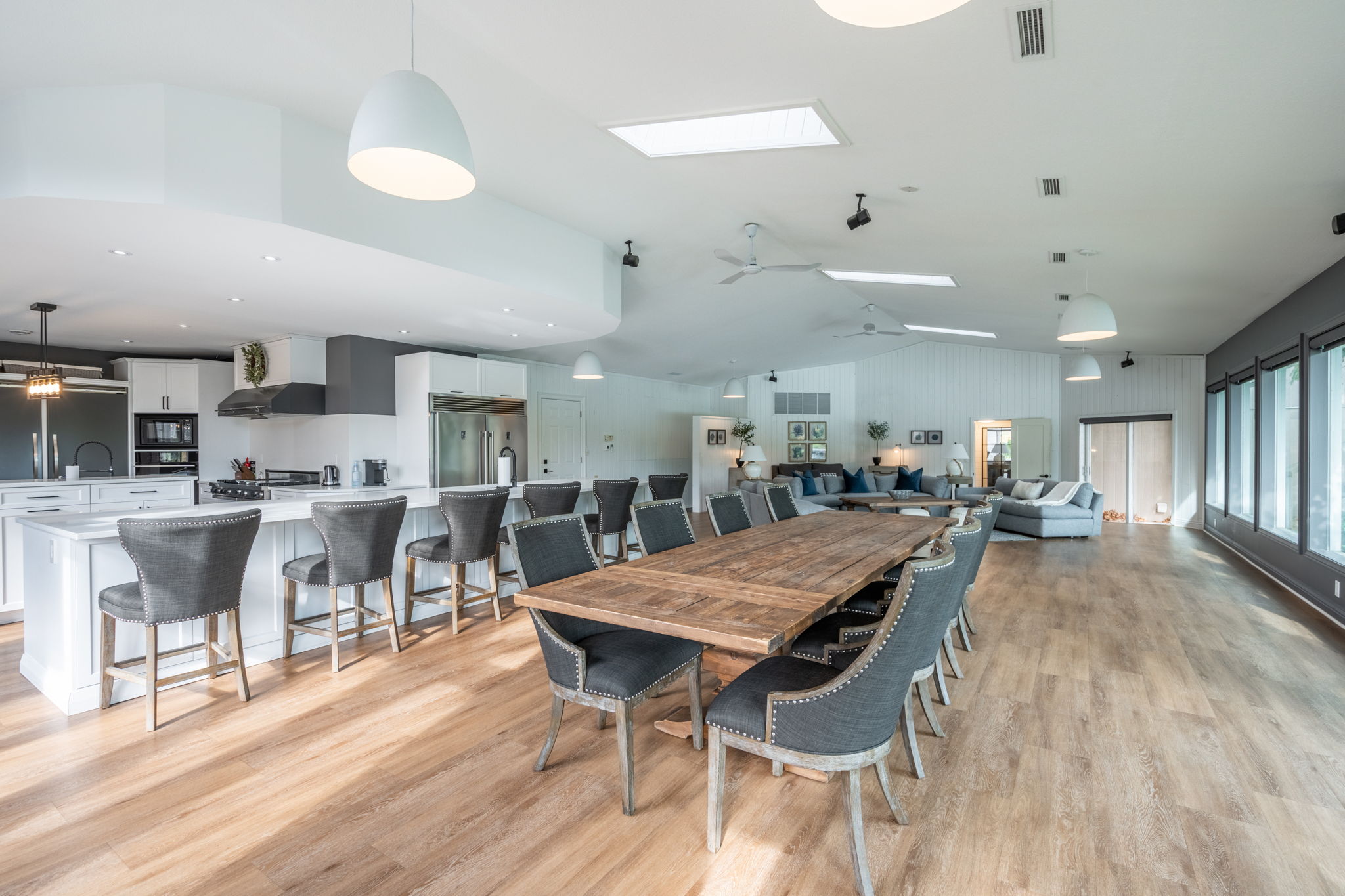 Open-concept interior dining area with large table and kitchen